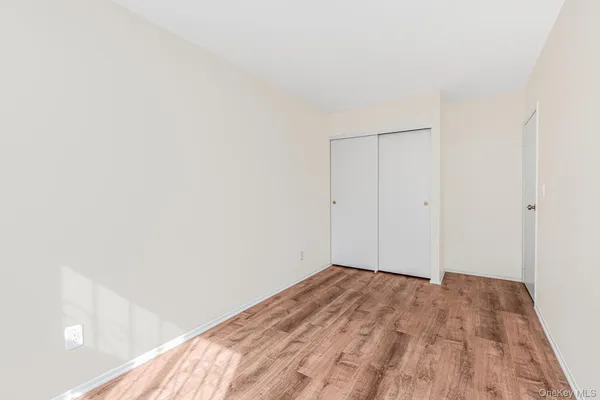 a view of a room with wooden floor