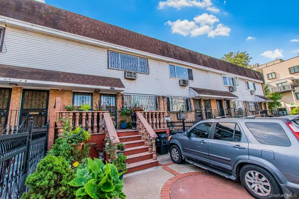 a front view of a residential apartment building with a yard