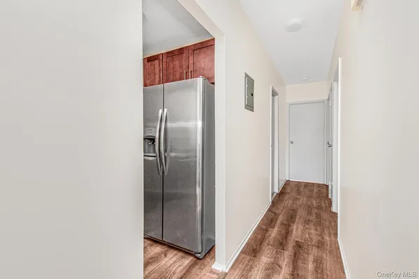 a view of a hallway with wooden floor