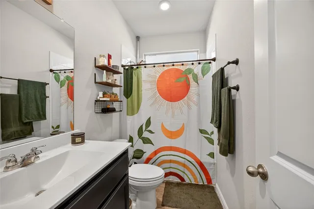 a bathroom with a double vanity sink mirror and shower