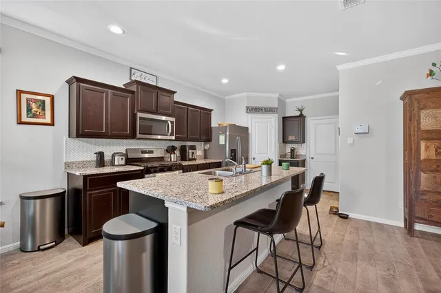 a open kitchen with stainless steel appliances granite countertop a lot of counter space and a sink