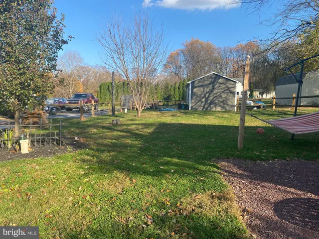 a view of a chairs and table in the backyard