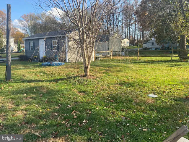 a view of backyard with wooden fence