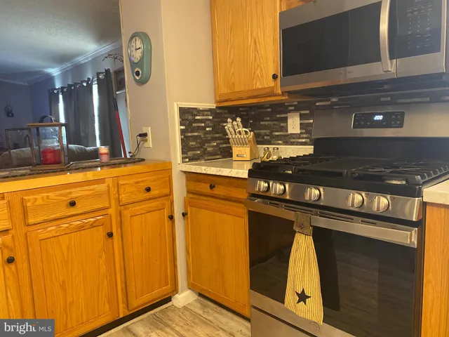 a kitchen with granite countertop cabinets and black appliances