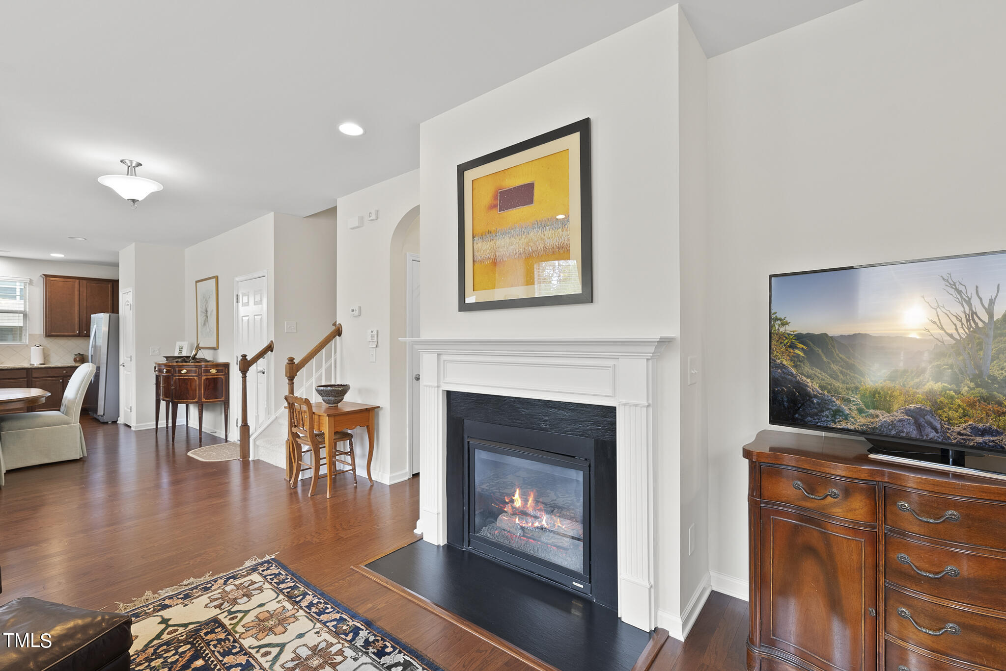 2 Intuition Circle Durham, NC 27705 - Photo 16 of 33 a living room with furniture a fireplace and a flat screen tv