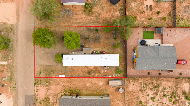 740 Riddle Drive Fredonia, AZ 86022 - Photo 20 of 20 Aerial view of a rectangular lot, outlined in red, featuring a single-story residence with a light-colored roof