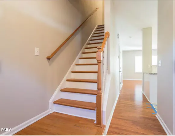 a view of a hallway with wooden floor and entryway