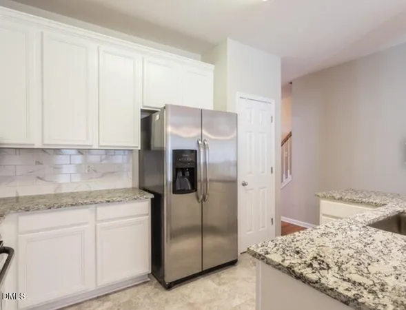 a kitchen with a refrigerator and cabinets
