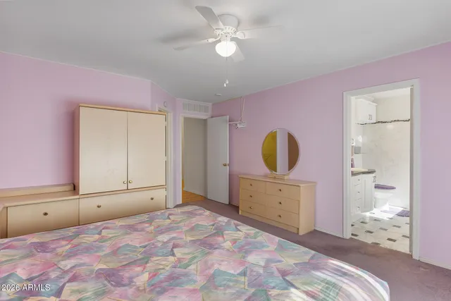 a bedroom with a bed and a dresser