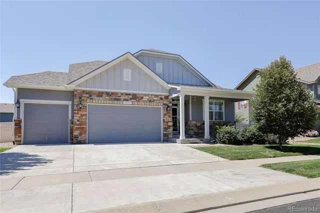 a front view of a house with garage and yard
