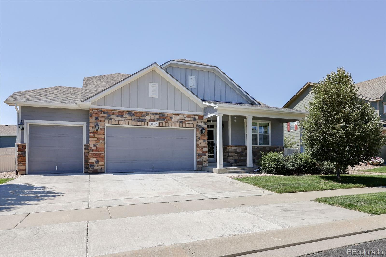 a front view of a house with garage and yard