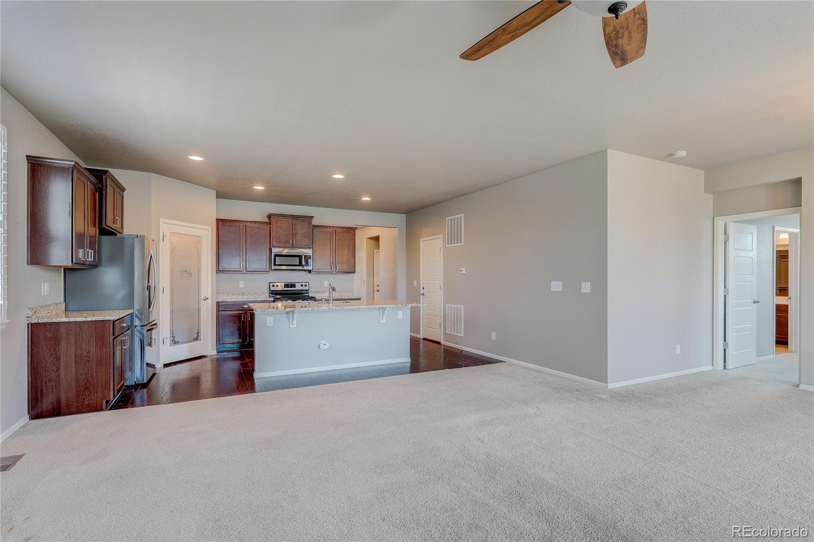 8891 Foxfire Street Firestone, CO 80504 - Photo 16 of 37 a view of a kitchen with refrigerator and window