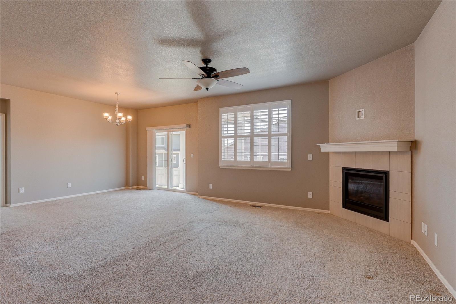 8891 Foxfire Street Firestone, CO 80504 - Photo 18 of 37 a view of an empty room with window and fireplace