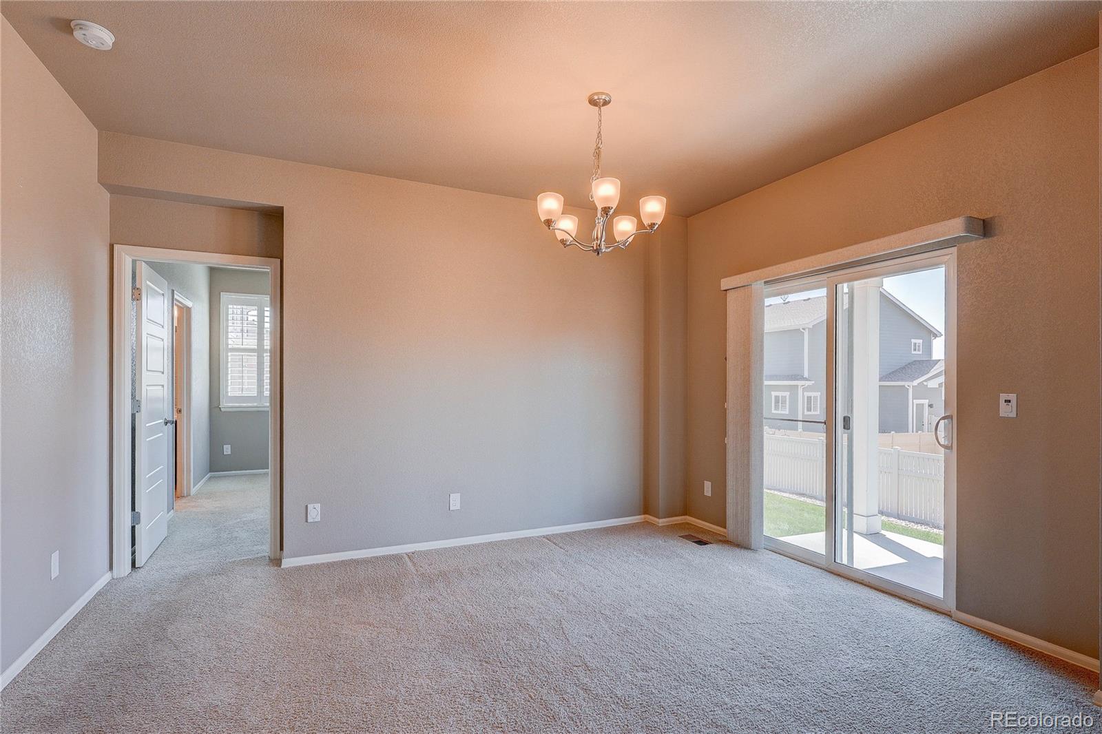 8891 Foxfire Street Firestone, CO 80504 - Photo 20 of 37 wooden floor in an empty room with a window