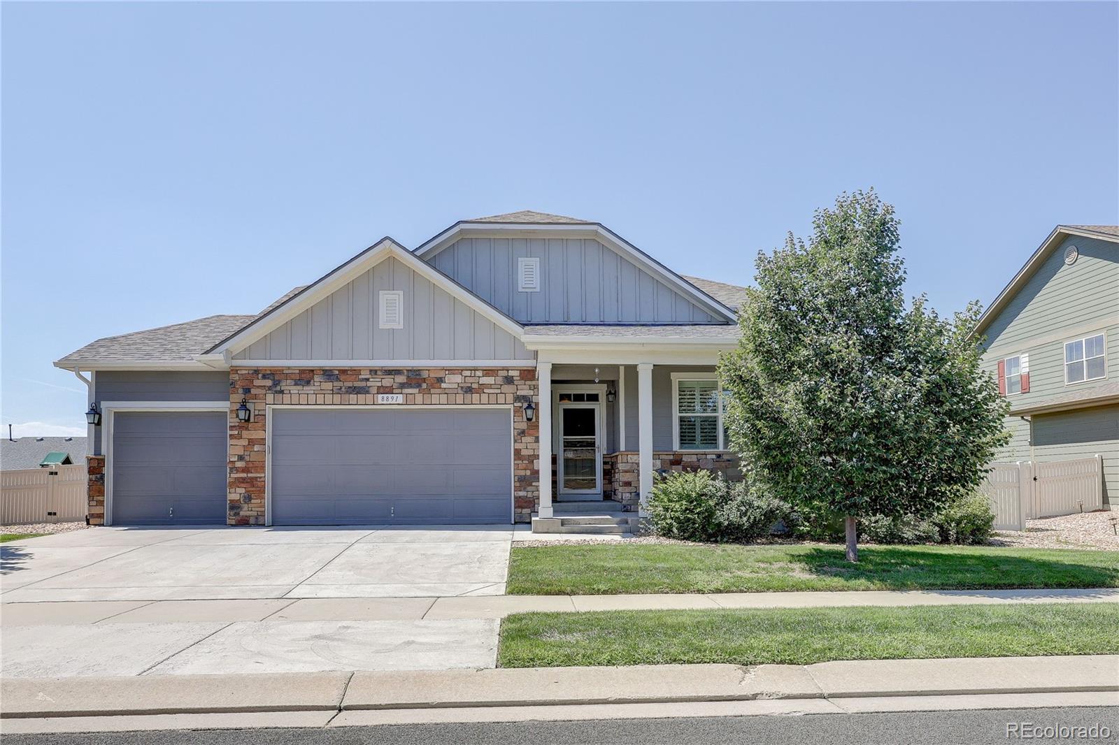 8891 Foxfire Street Firestone, CO 80504 - Photo 2 of 37 a front view of a house with a garden and plants