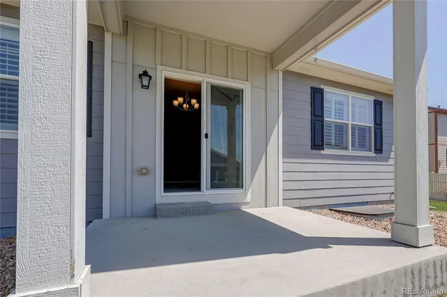 a view of a brick house with a door and a window