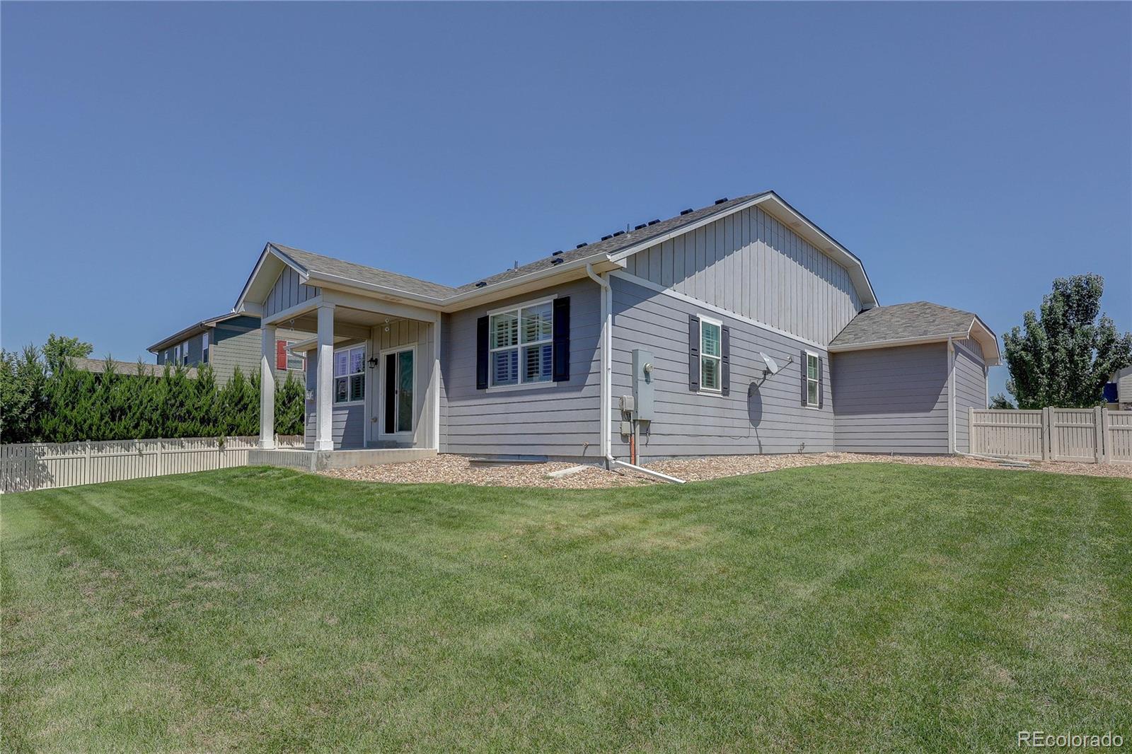 8891 Foxfire Street Firestone, CO 80504 - Photo 32 of 37 a front view of a house with a yard and garage