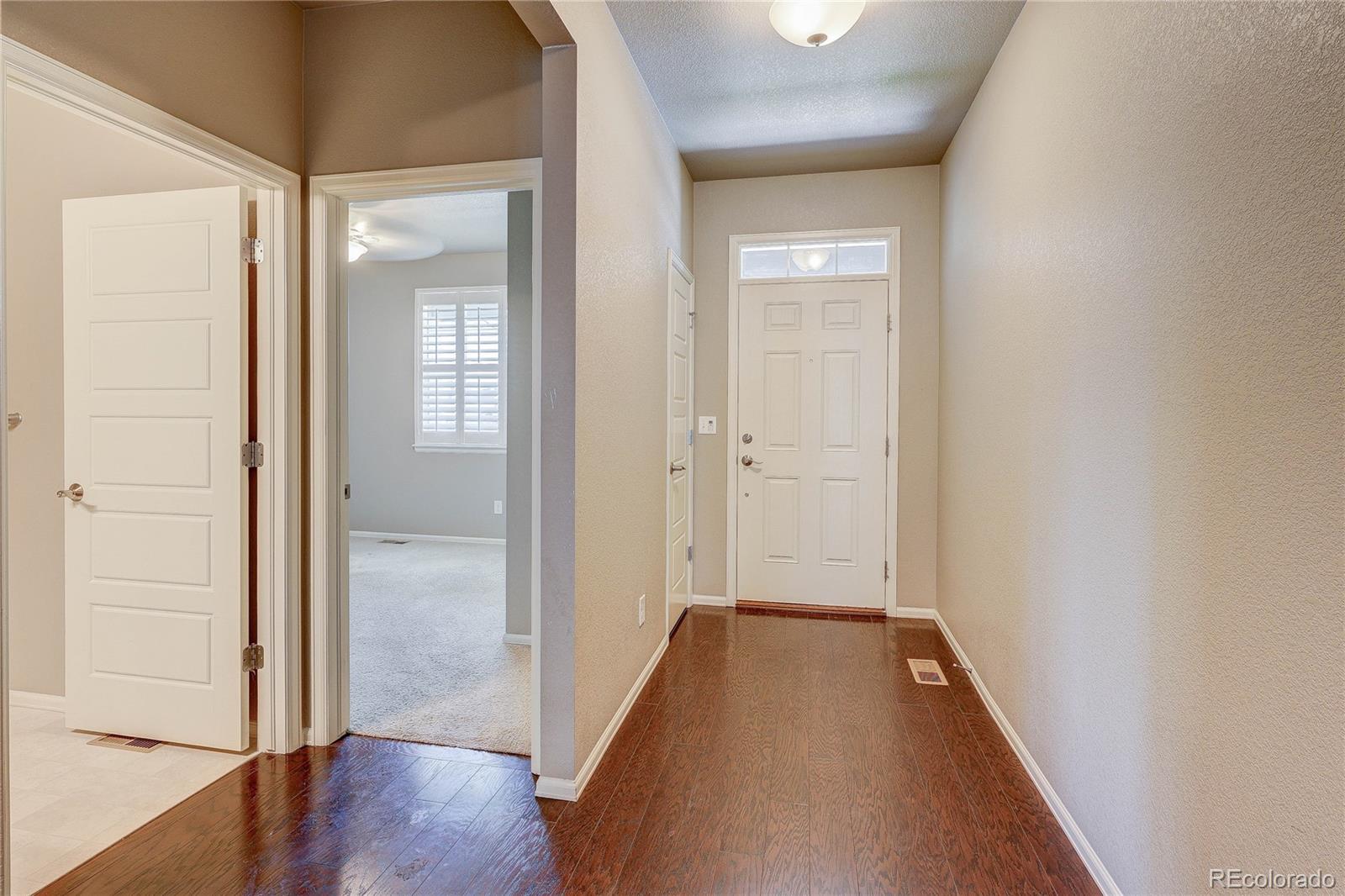 8891 Foxfire Street Firestone, CO 80504 - Photo 4 of 37 a view of a hallway with wooden floor
