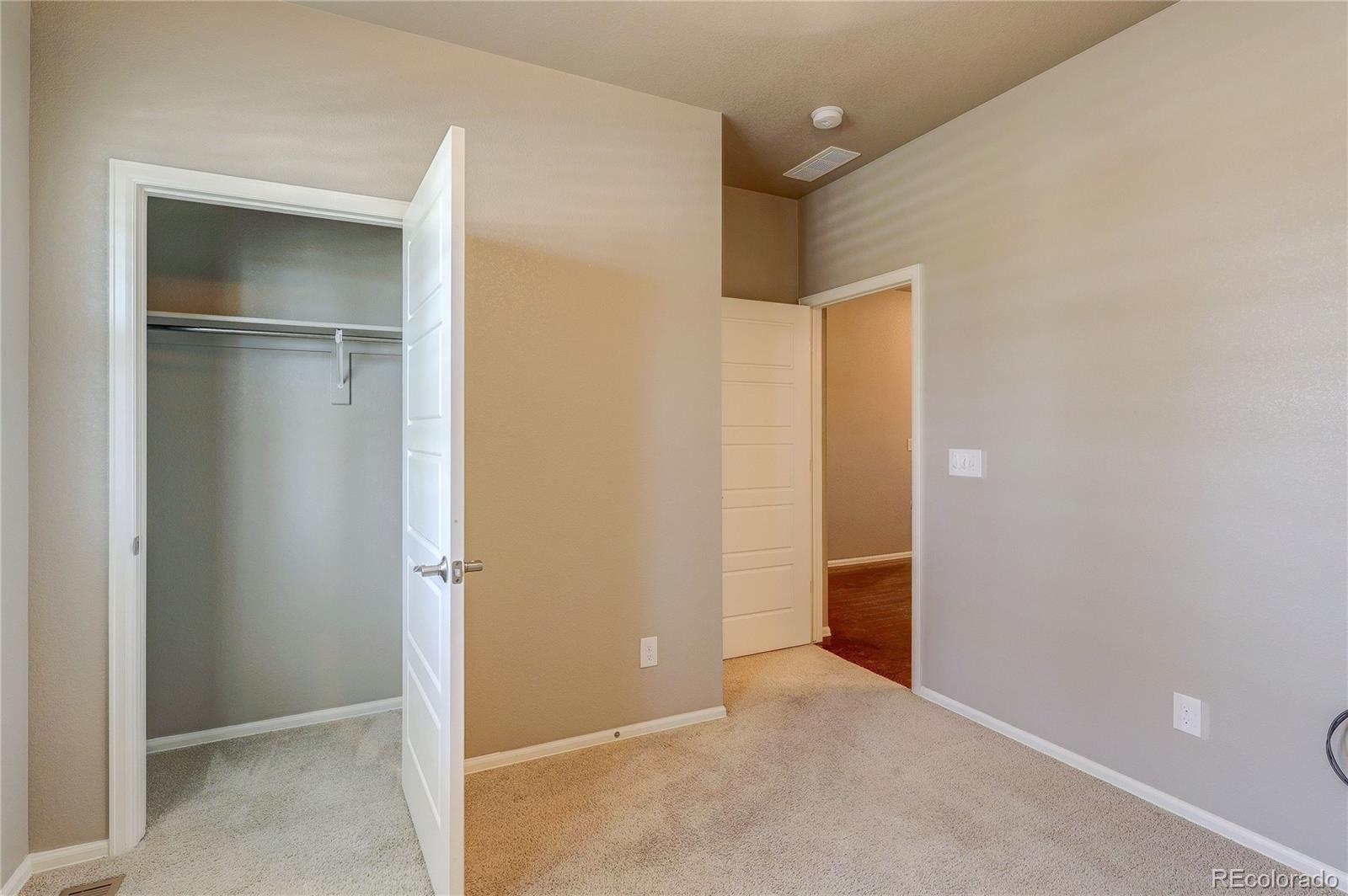 8891 Foxfire Street Firestone, CO 80504 - Photo 5 of 37 a view of an empty room with closet and wooden door