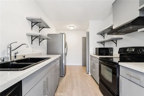 a kitchen with stainless steel appliances granite countertop a sink and cabinets