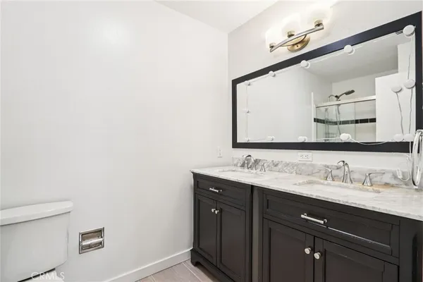 a bathroom with a double vanity sink and a mirror