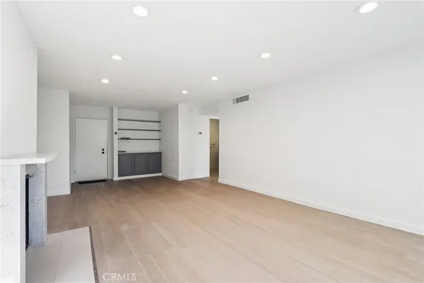 a view of an empty room with a fireplace