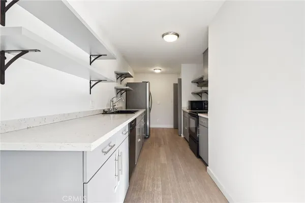 a kitchen with a refrigerator and a sink
