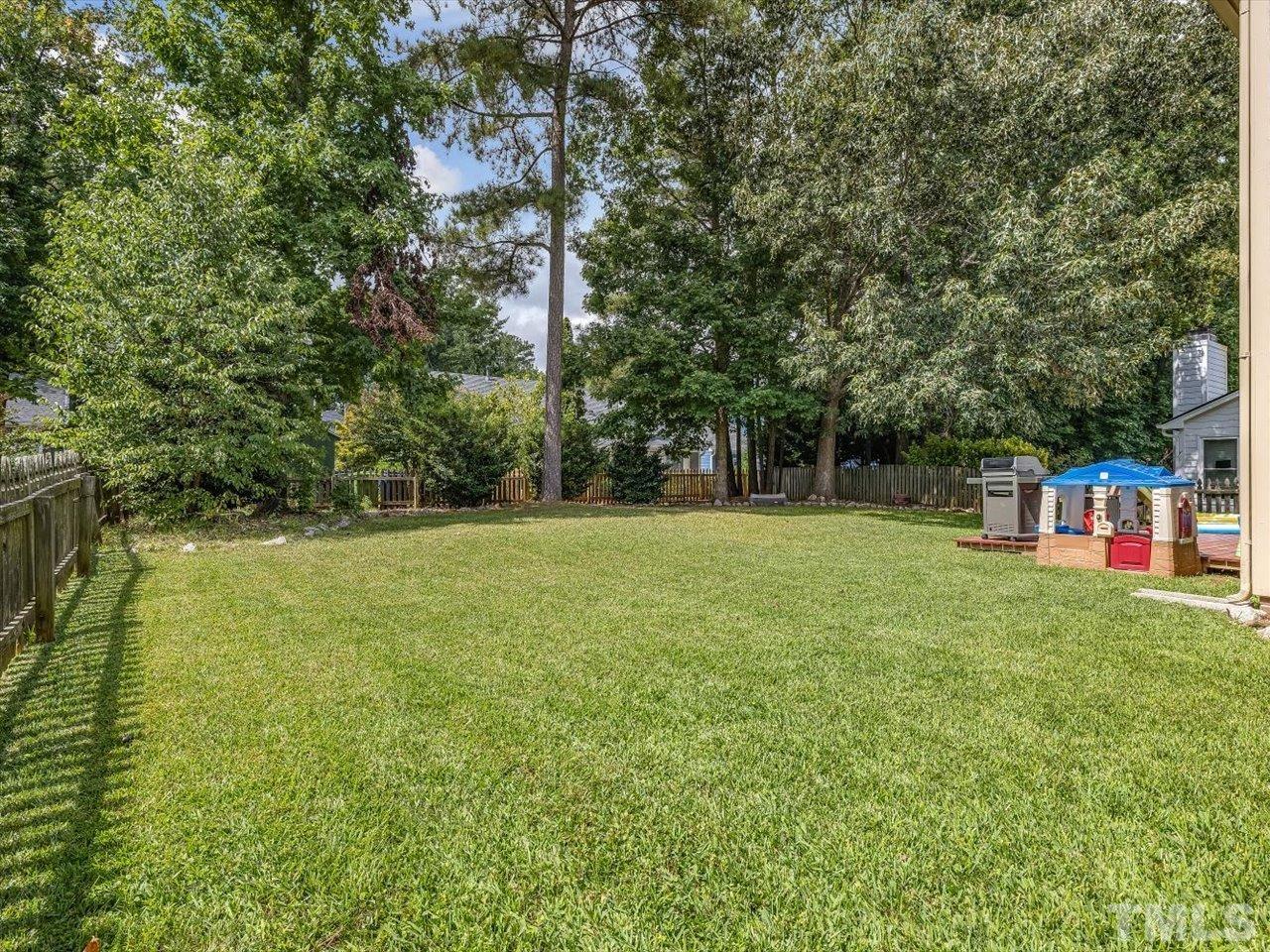 11220 North Radner Way Raleigh, NC 27613 - Photo 11 of 24 a view of a field with trees in the background