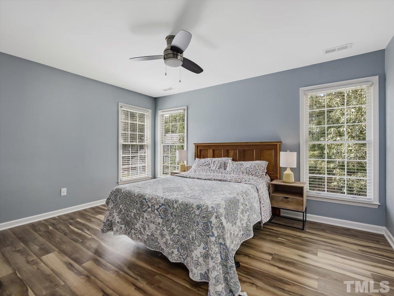 11220 North Radner Way Raleigh, NC 27613 - Photo 14 of 24 a bedroom with a large bed and a window