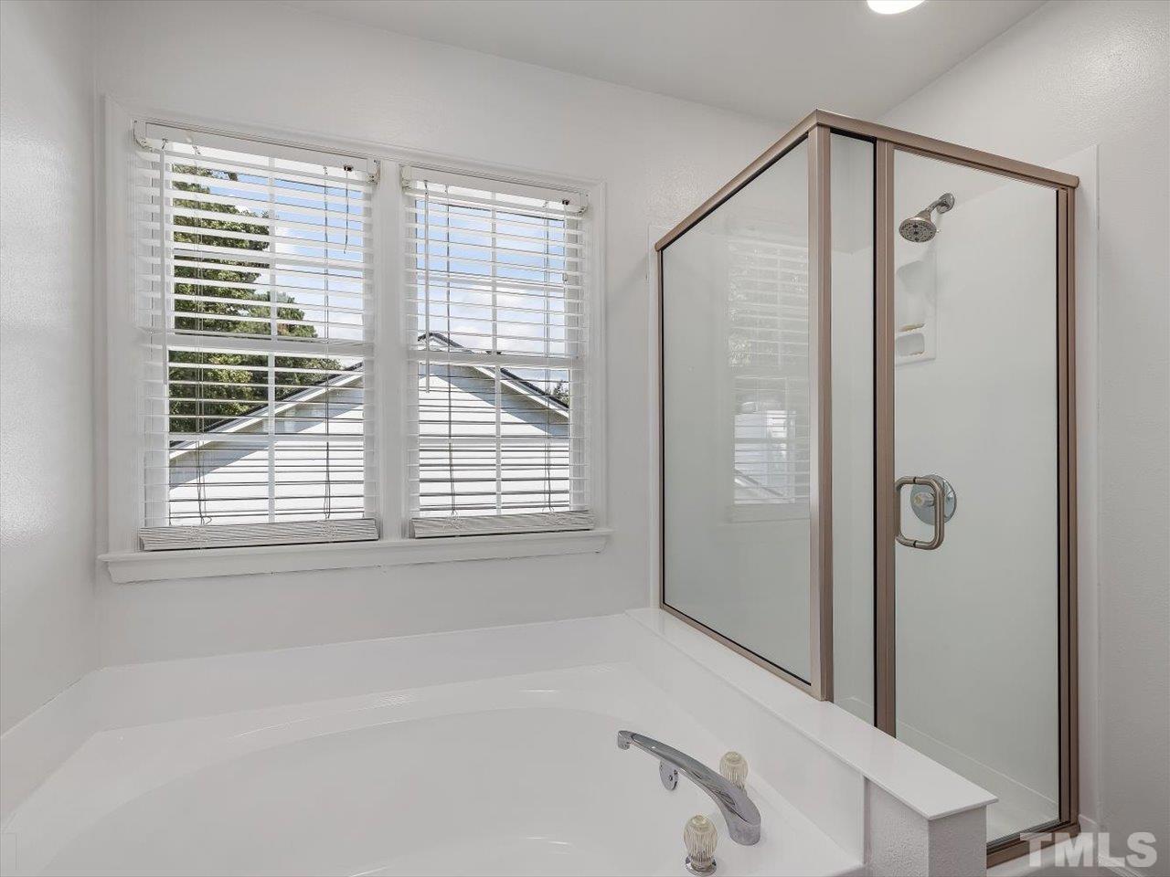 11220 North Radner Way Raleigh, NC 27613 - Photo 16 of 24 a bathroom with a bathtub and a shower