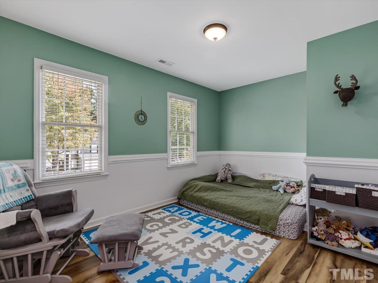 11220 North Radner Way Raleigh, NC 27613 - Photo 17 of 24 a bed room with a bed and a chair