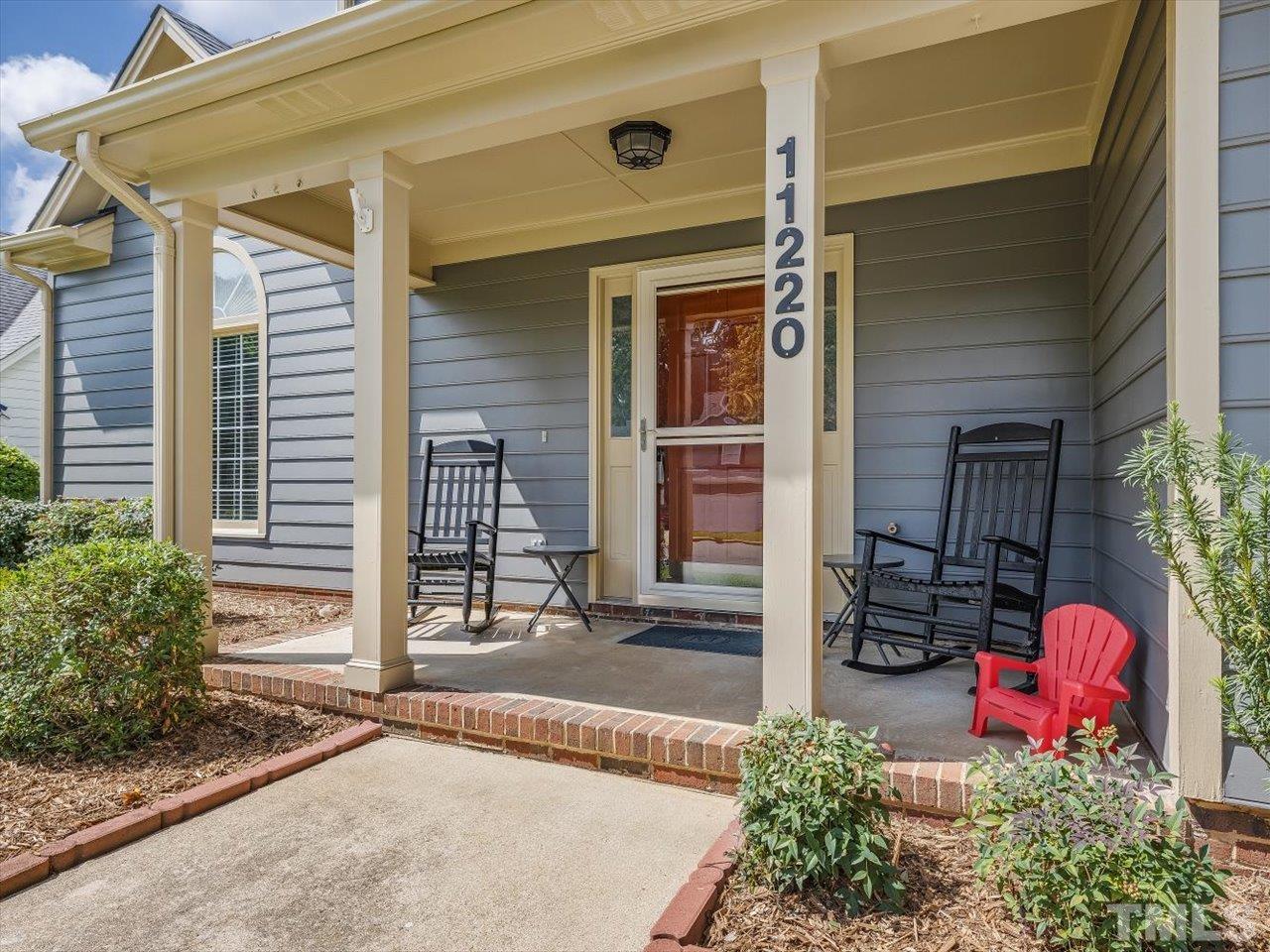 11220 North Radner Way Raleigh, NC 27613 - Photo 2 of 24 a front view of a house with a yard