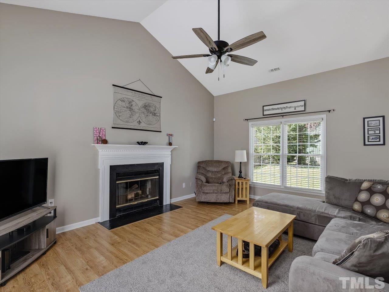 11220 North Radner Way Raleigh, NC 27613 - Photo 3 of 24 a living room with furniture and a fireplace
