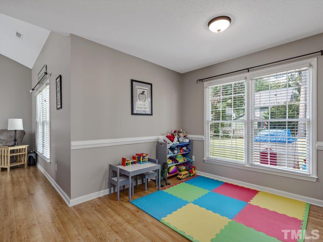 11220 North Radner Way Raleigh, NC 27613 - Photo 5 of 24 a living room with furniture and a floor to ceiling window