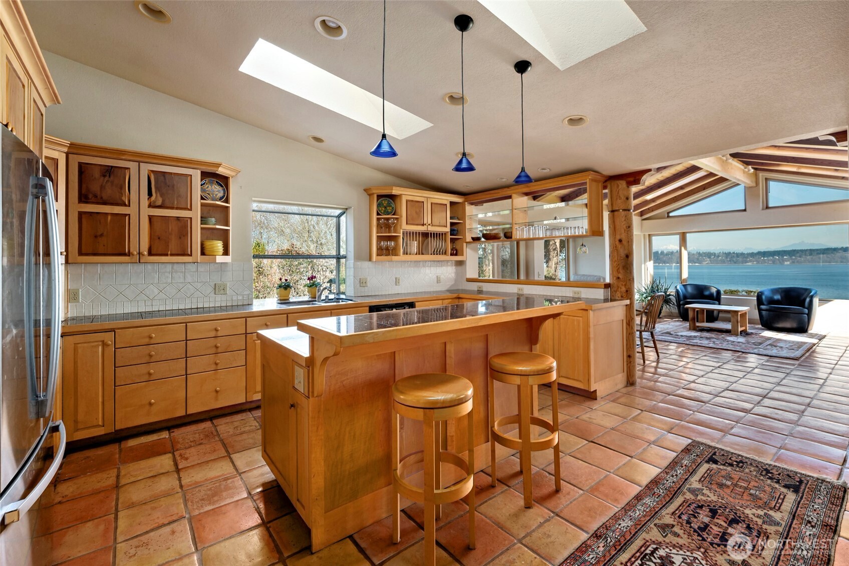 5477 Wilkinson Road Langley, WA 98260 - Photo 15 of 40 a kitchen with stainless steel appliances granite countertop a sink a stove and a wooden floors