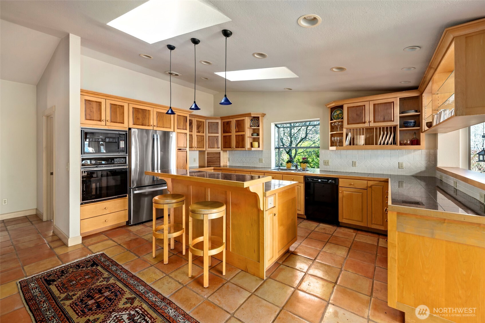 5477 Wilkinson Road Langley, WA 98260 - Photo 16 of 40 a kitchen with stainless steel appliances granite countertop a stove and a sink