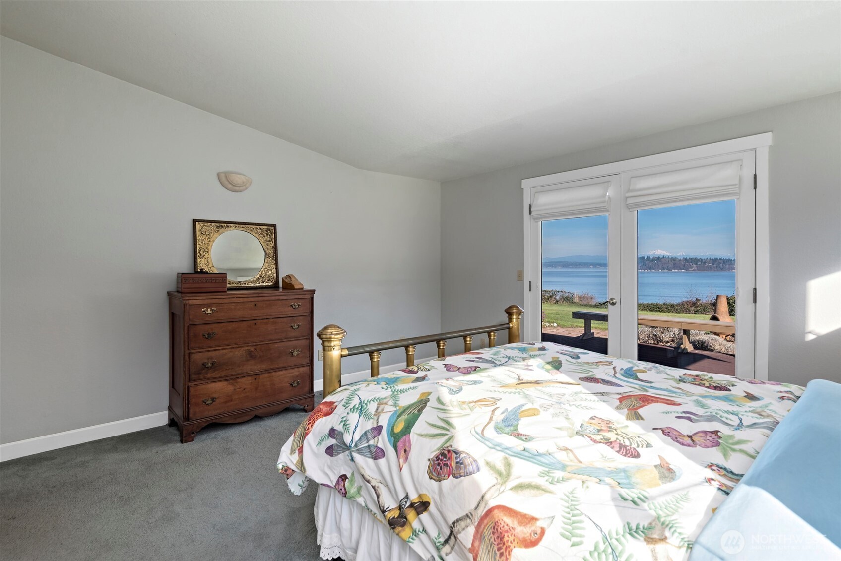 5477 Wilkinson Road Langley, WA 98260 - Photo 21 of 40 a bedroom with a bed and a dresser