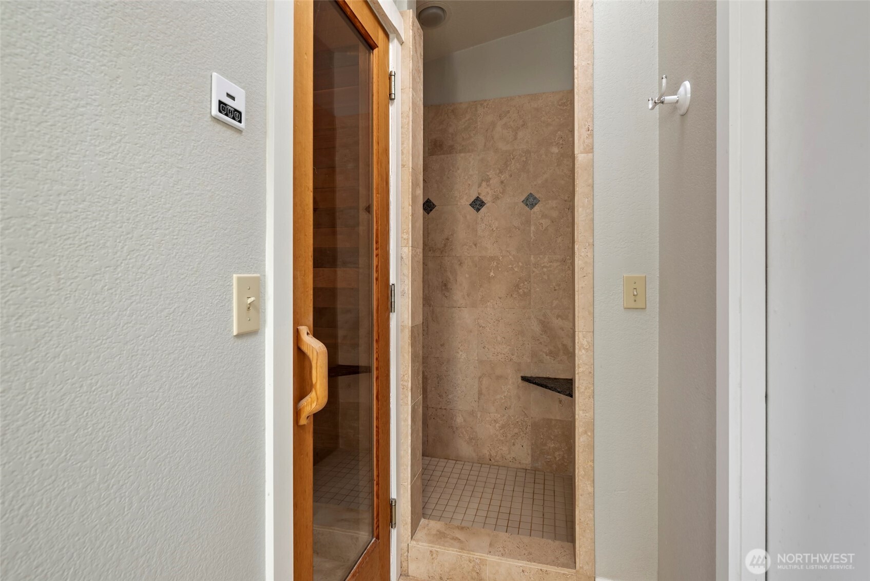5477 Wilkinson Road Langley, WA 98260 - Photo 23 of 40 a bathroom with a glass shower door