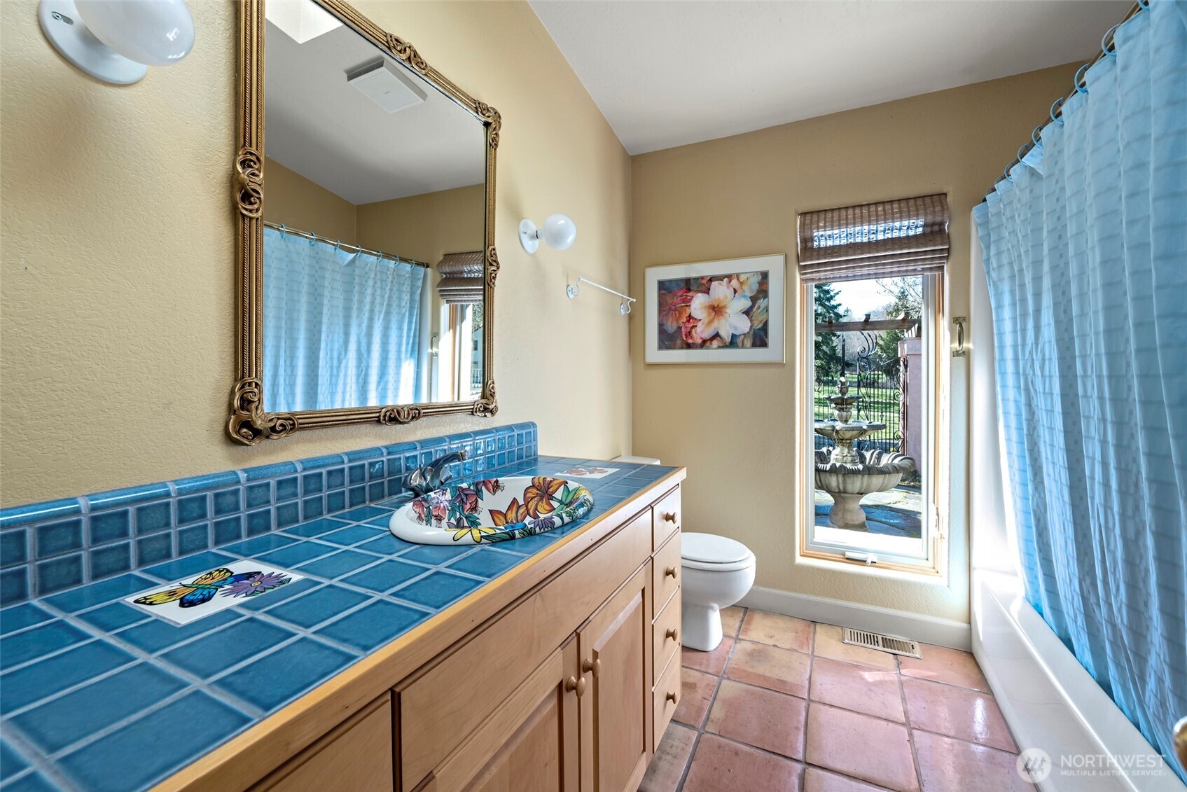 5477 Wilkinson Road Langley, WA 98260 - Photo 25 of 40 a bathroom with a sink a toilet and a shower curtain