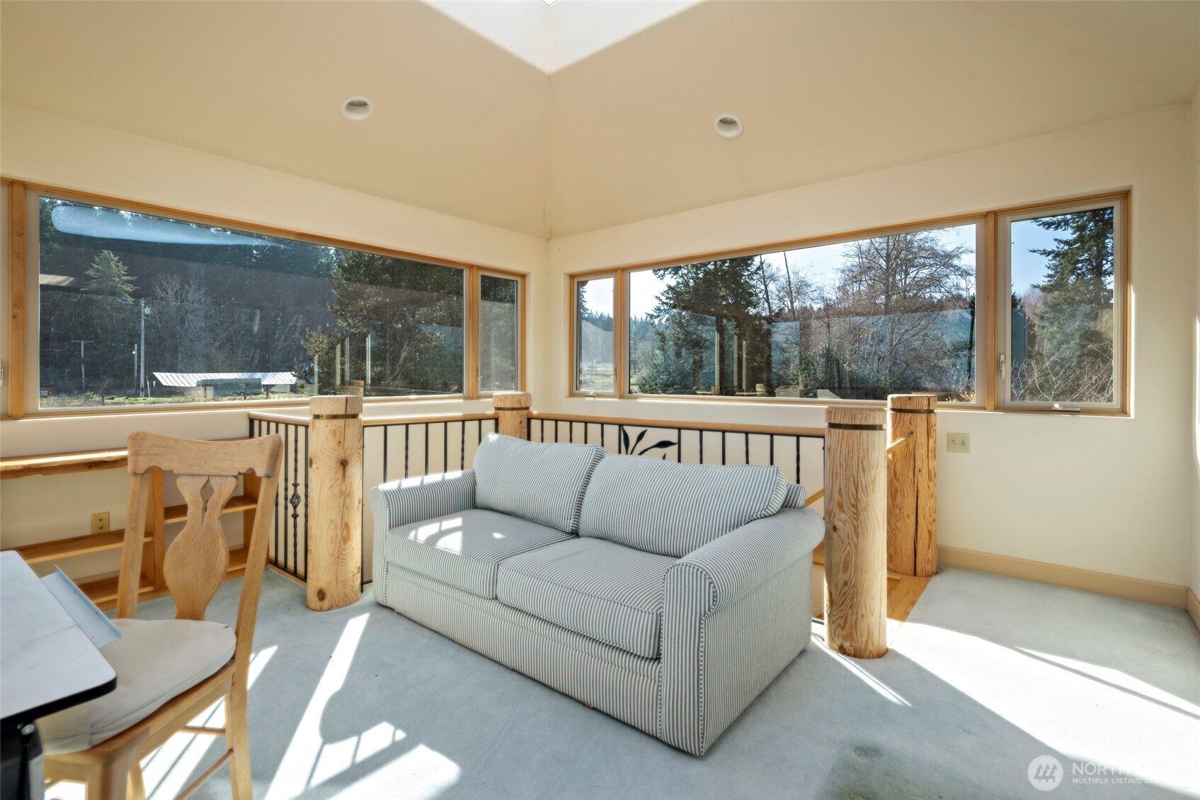5477 Wilkinson Road Langley, WA 98260 - Photo 27 of 40 a living room with furniture and a large window