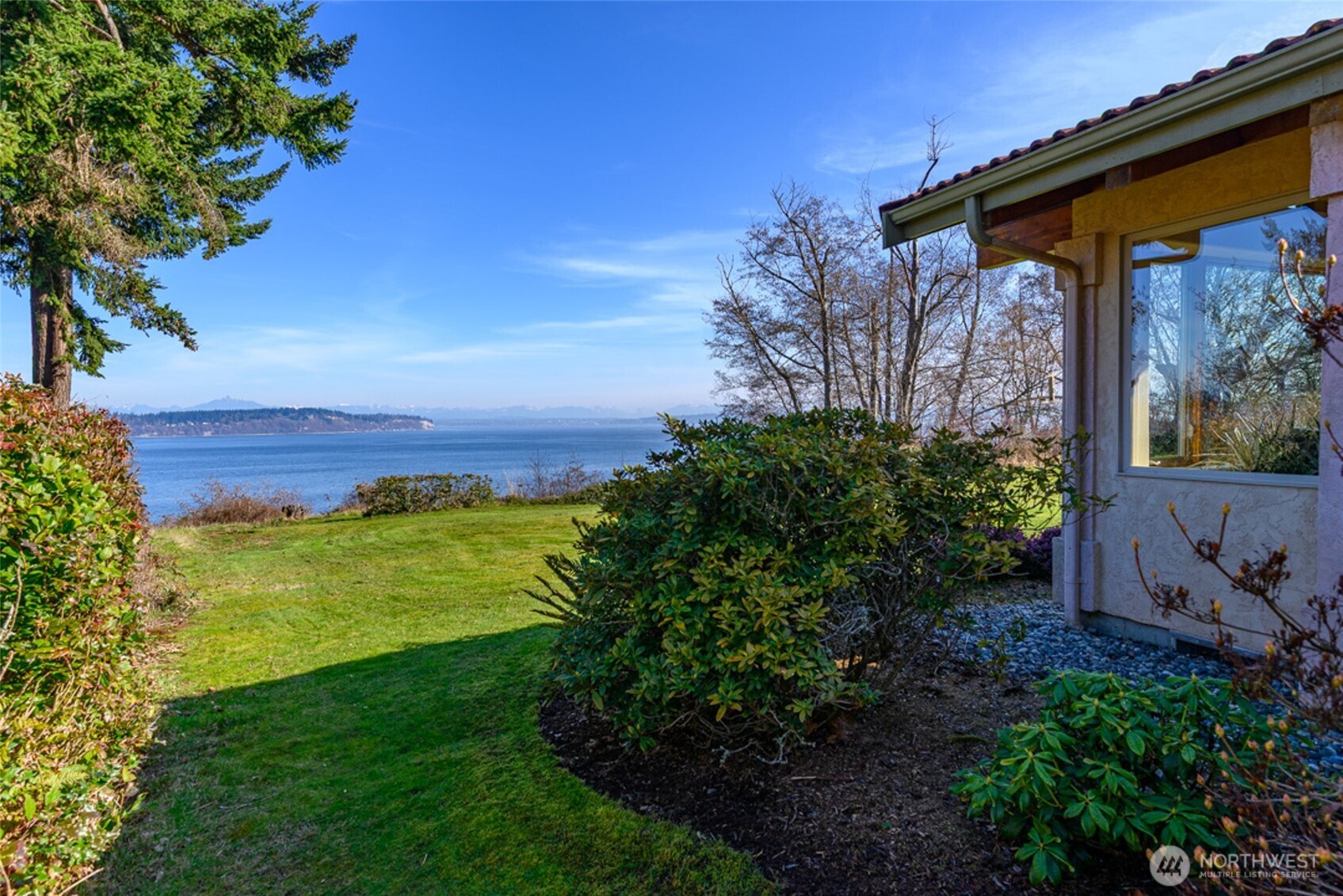 5477 Wilkinson Road Langley, WA 98260 - Photo 30 of 40 a view of a backyard with plants and a patio