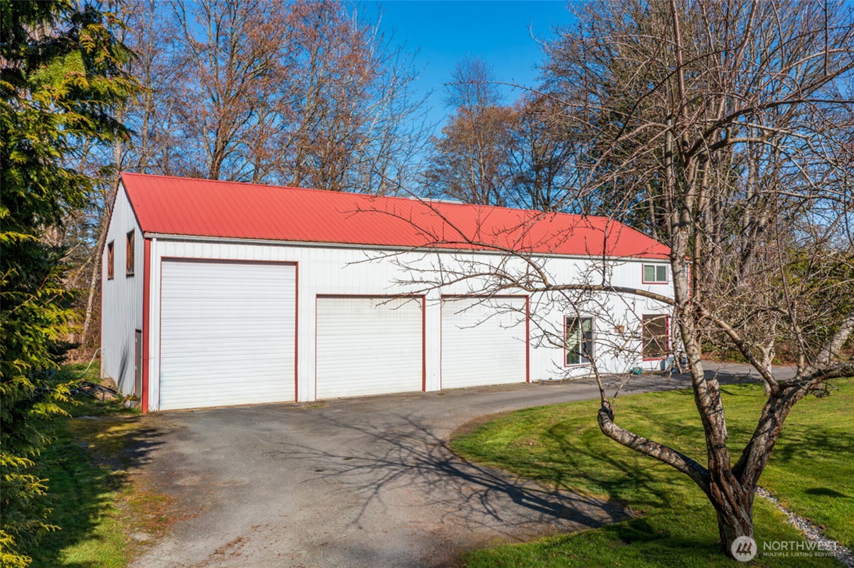 5477 Wilkinson Road Langley, WA 98260 - Photo 32 of 40 a yellow and red umbrella in front of house