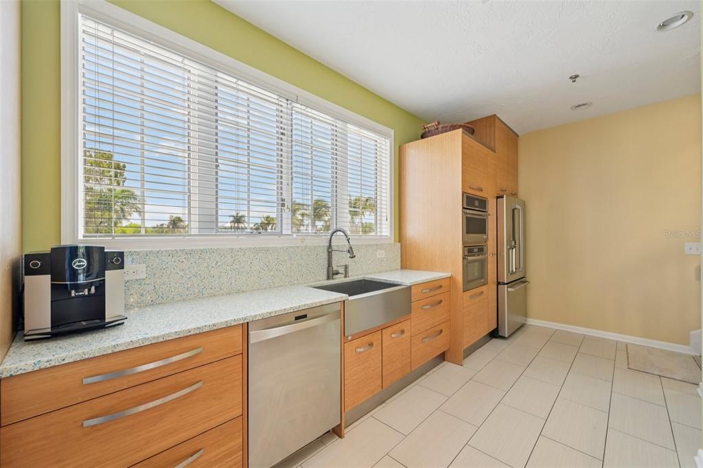 660 Cedars Court Longboat Key, FL 34228 - Photo 11 of 35 a kitchen with stainless steel appliances granite countertop a sink and a window