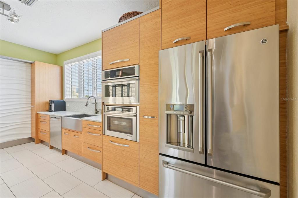 660 Cedars Court Longboat Key, FL 34228 - Photo 12 of 35 a kitchen with stainless steel appliances a refrigerator sink and cabinets