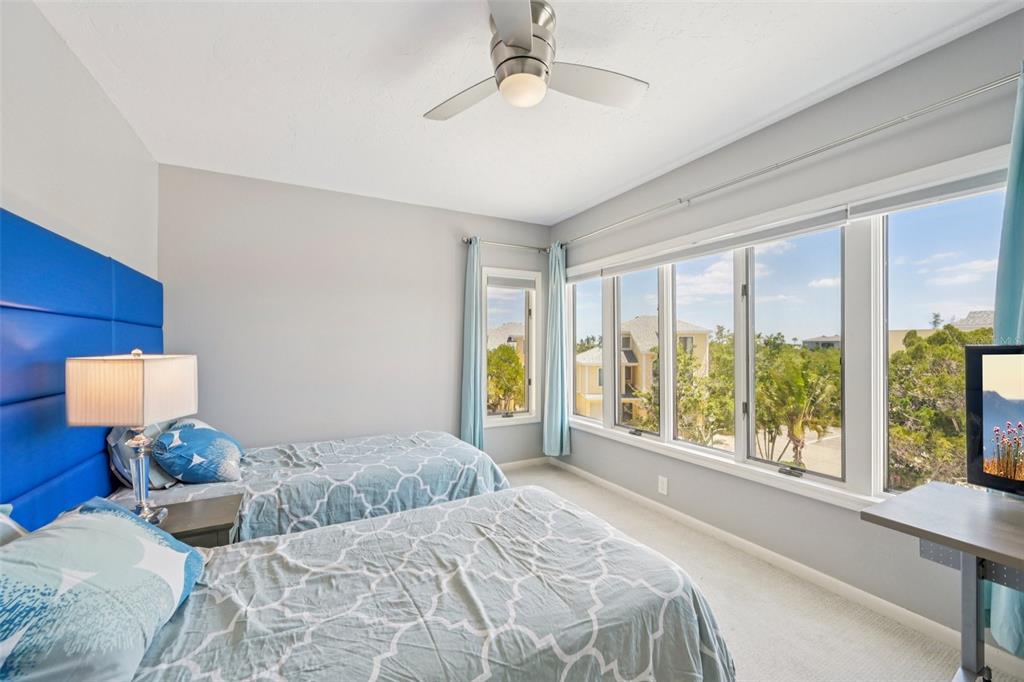 660 Cedars Court Longboat Key, FL 34228 - Photo 13 of 35 a bedroom with a large bed and a large window