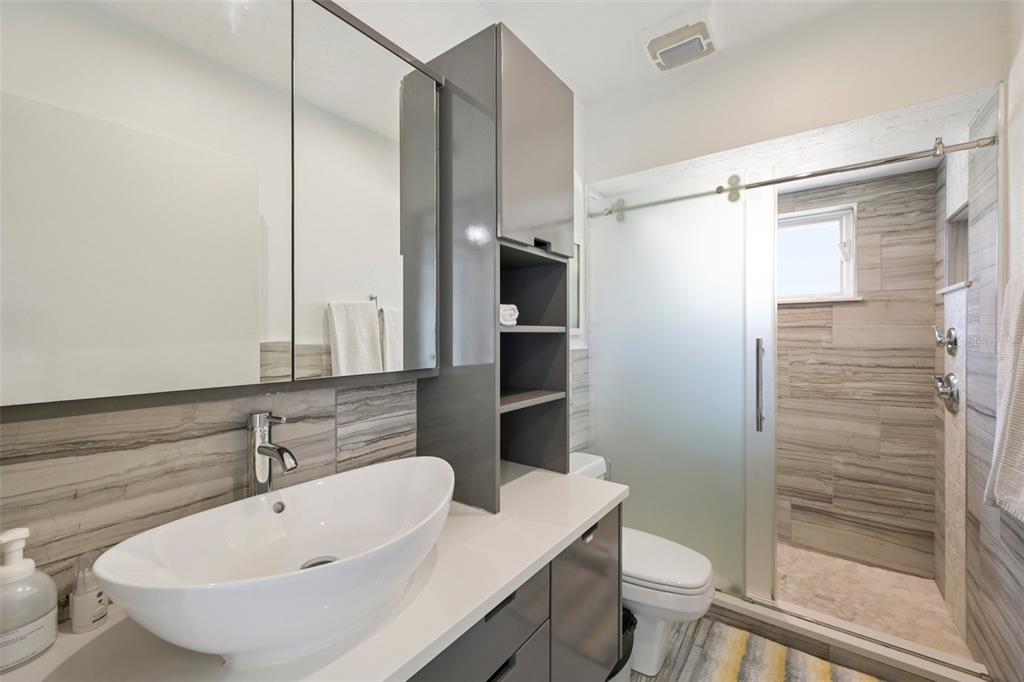 660 Cedars Court Longboat Key, FL 34228 - Photo 15 of 35 a bathroom with a sink a toilet and shower