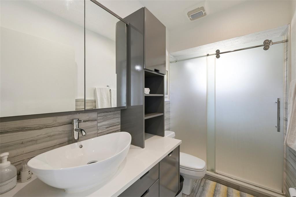 660 Cedars Court Longboat Key, FL 34228 - Photo 16 of 35 a bathroom with a sink a toilet and shower