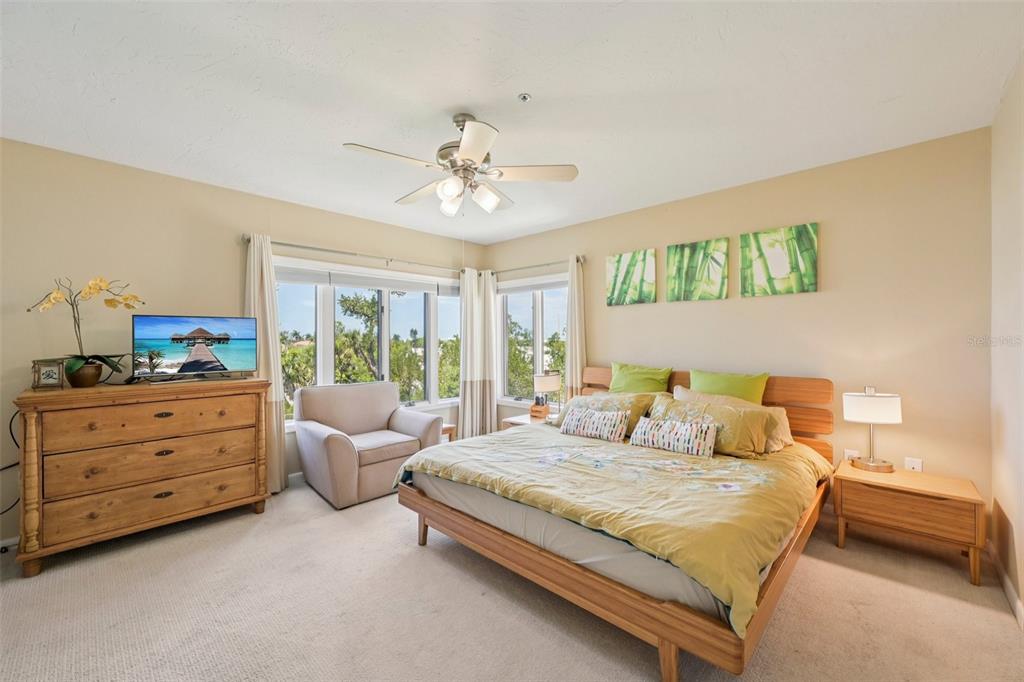 660 Cedars Court Longboat Key, FL 34228 - Photo 17 of 35 a bedroom with a bed and a chandelier