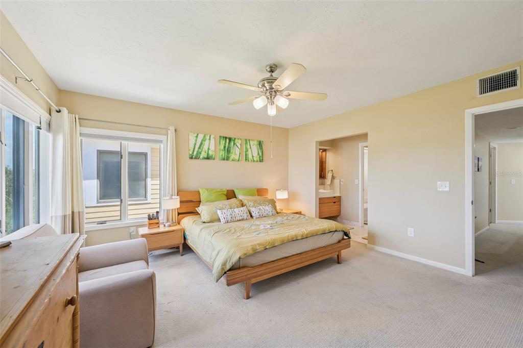 660 Cedars Court Longboat Key, FL 34228 - Photo 18 of 35 a bedroom with a bed couch and windows