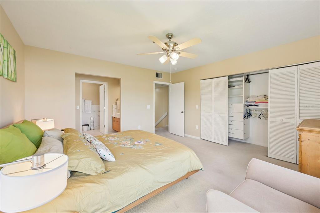 660 Cedars Court Longboat Key, FL 34228 - Photo 19 of 35 a spacious bedroom with a bed and a couch